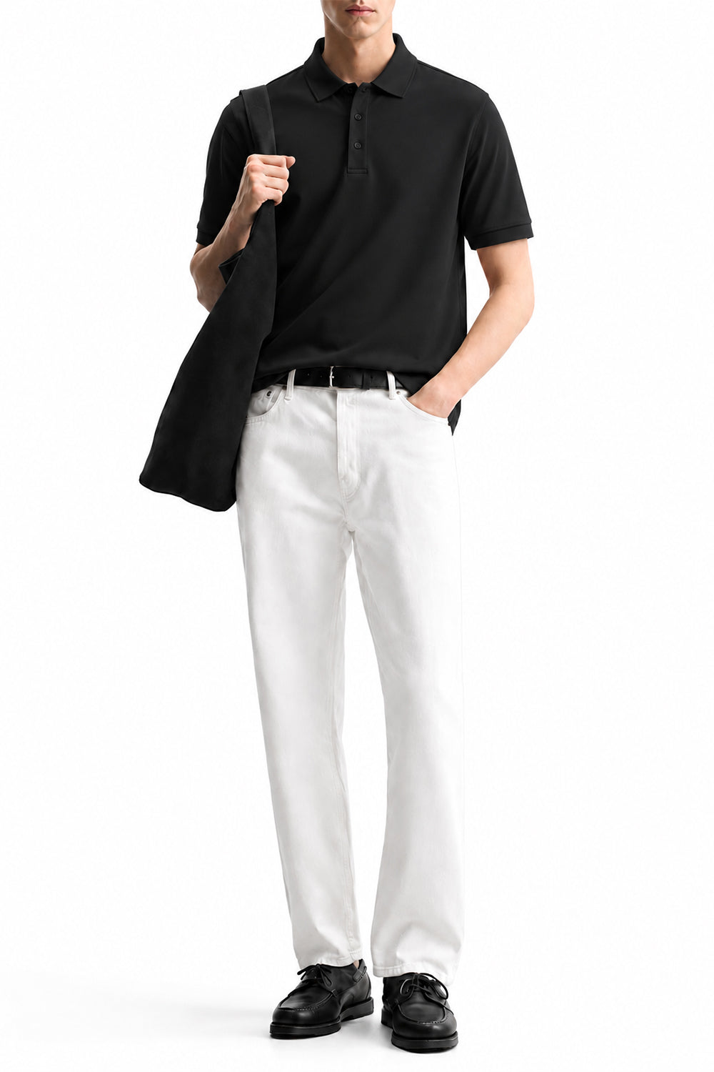 Man wearing the Black Airloop Polo with white trousers