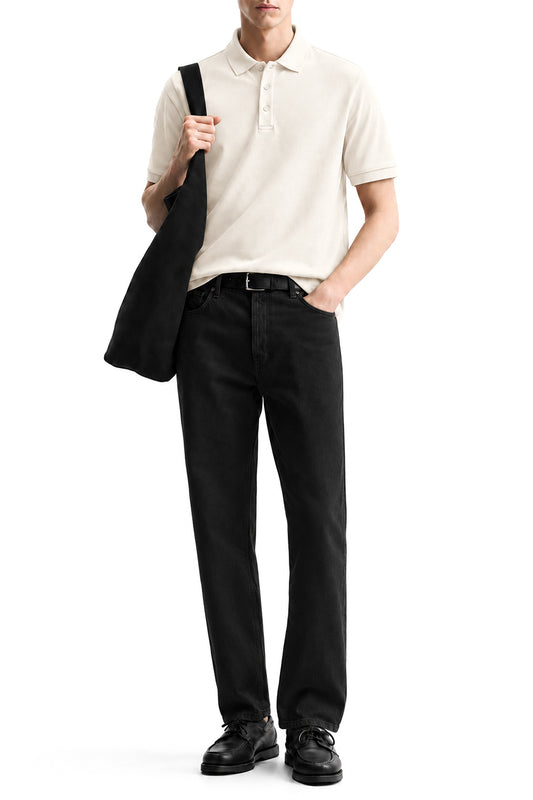 Man wearing the White Airloop Polo with black trousers
