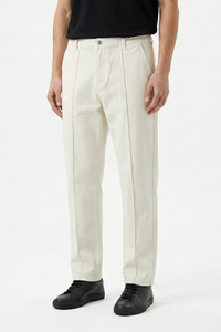 Cropped front shot of a man wearing off-white, straight-leg Denim Pant