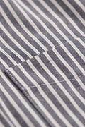 Striped Shirt focusing on the neatly aligned vertical patterns of the fabric and chest pocket.