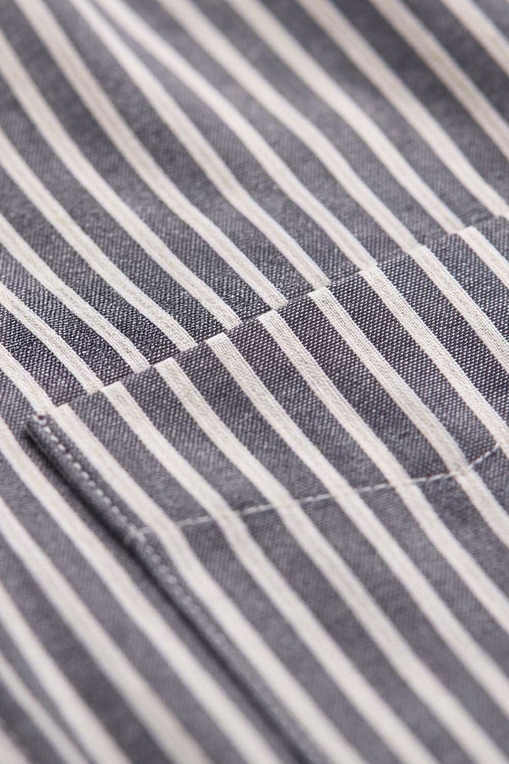 Striped Shirt focusing on the neatly aligned vertical patterns of the fabric and chest pocket.