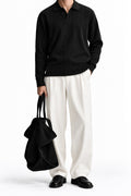 Man wearing the Black Dropneedle Full Sleeve Polo with cream trousers