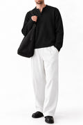 Man wearing IVAR black dropneedle full sleeve henley with white trousers