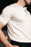 Close-up of man wearing cream Henley highlighting fabric texture and fit
