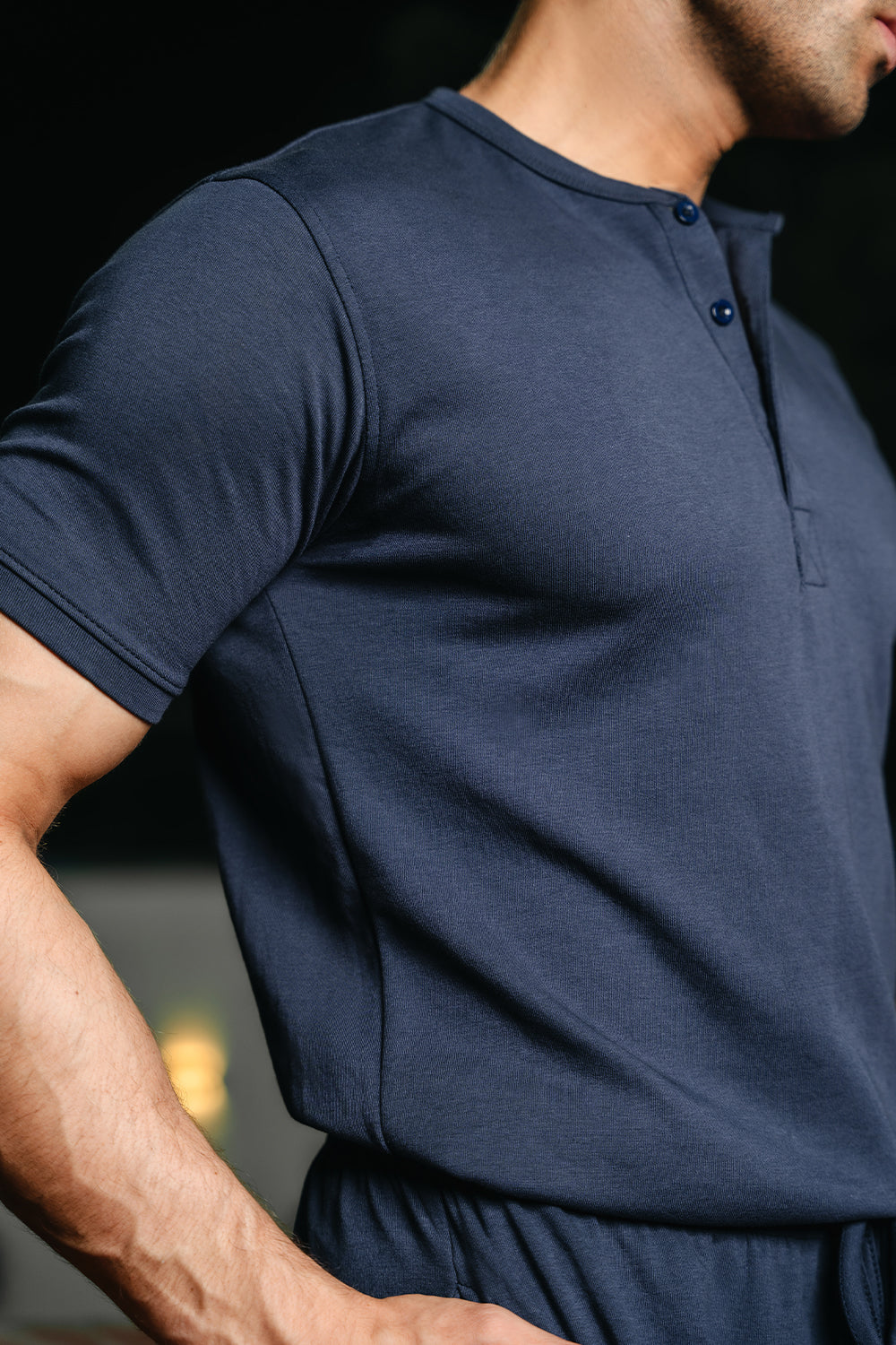 Close-up of man wearing navy Henley highlighting fabric texture and fit
