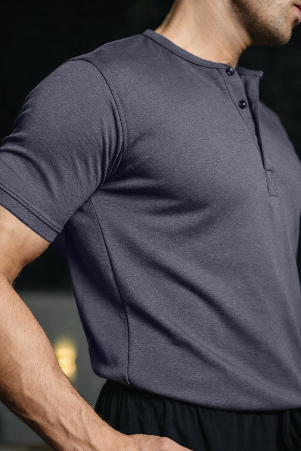 Close-up of man wearing navy Henley highlighting fabric texture and fit

