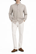 Man wearing beige Collar Linen Shirt paired with white trousers and brown shoes
