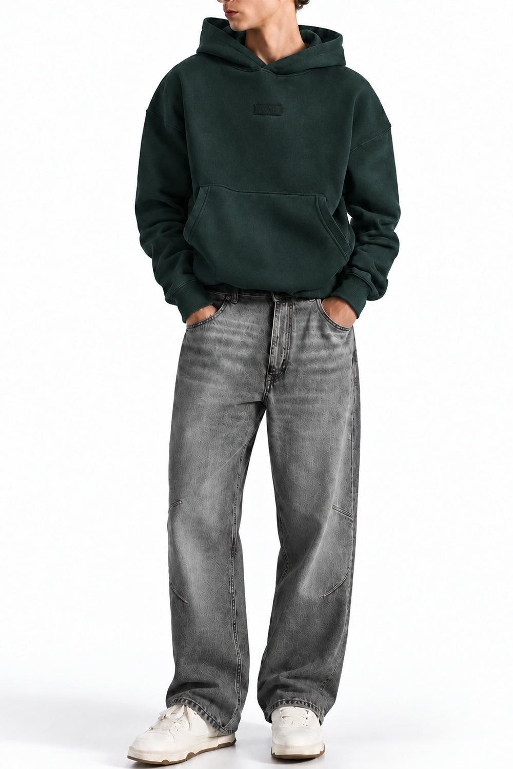 Man wearing the Deep Forest NYC Hoodie with grey jeans, front view