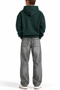 Man wearing the Deep Forest NYC Hoodie with grey jeans, back view