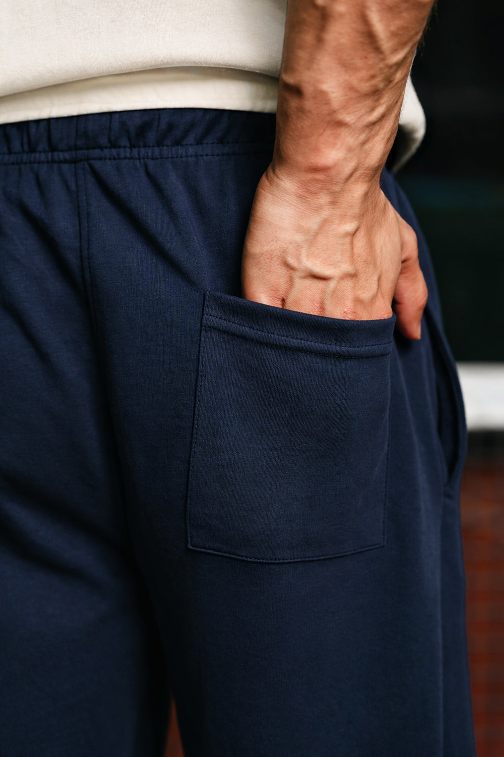 Close-up of navy Pants highlighting back pocket and elastic waistband detail