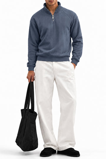 Man wearing the Grey Raglan Drop Needle Quarter Zipper with white trousers, front view