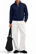 Man wearing the Navy Raglan Drop Needle Quarter Zipper with white trousers, front view