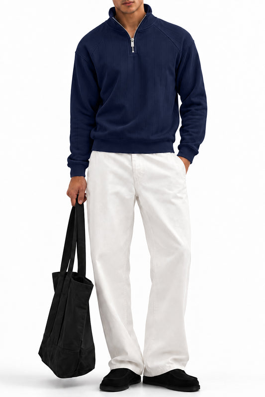 Man wearing the Navy Raglan Drop Needle Quarter Zipper with white trousers, front view