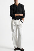 Man wearing the Black Ribbed 5 Button Henley with white trousers, front view