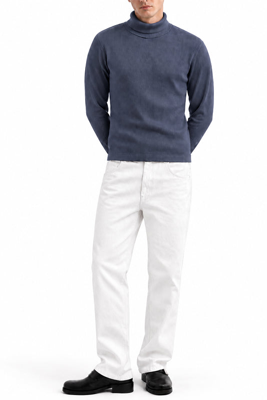 Man wearing the Grey Ribbed Highneck with white trousers