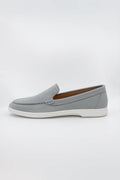 Suede Loafers shoe featuring detailed moc-toe stitching and a contrasting white rubber sole