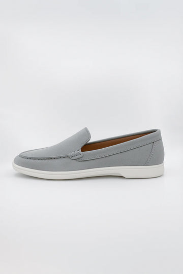 Suede Loafers shoe featuring detailed moc-toe stitching and a contrasting white rubber sole