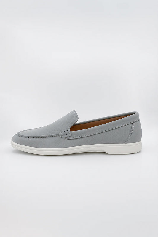 Suede Loafers shoe featuring detailed moc-toe stitching and a contrasting white rubber sole