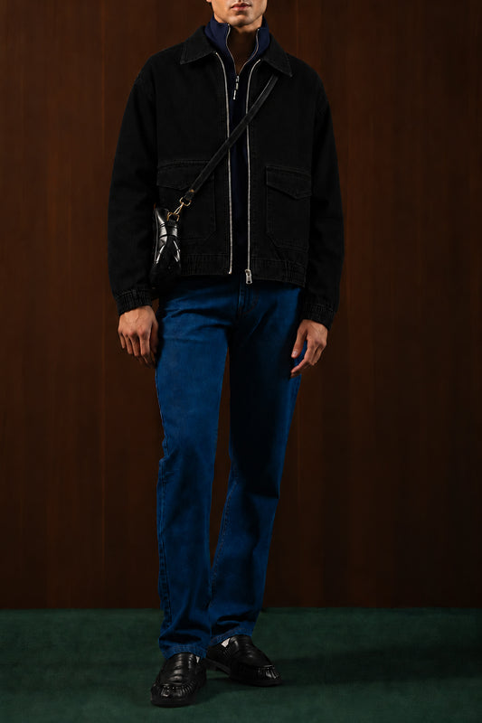 Man wearing the Black Workshop Denim Jacket with blue jeans, front view
